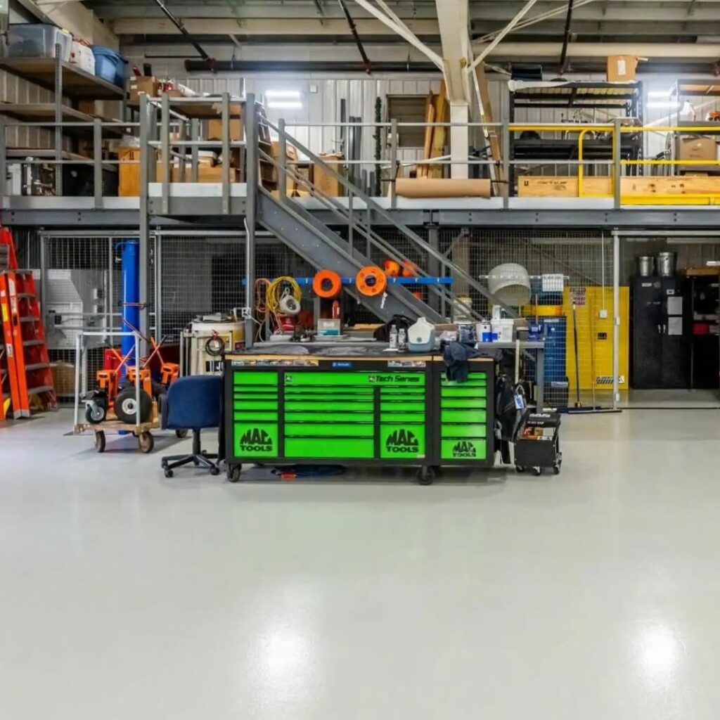 An industrial floor with a Penntek coating, showcasing its smooth, durable, and high-performance surface, designed to withstand heavy machinery, foot traffic, and harsh conditions. Elite Coatings offers fast-installation of polyurea concrete coatings for Houston home and businesses.