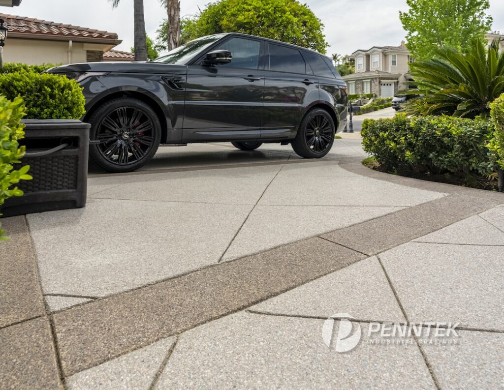 penntek products a polyurea concrete coated driveway with a black car