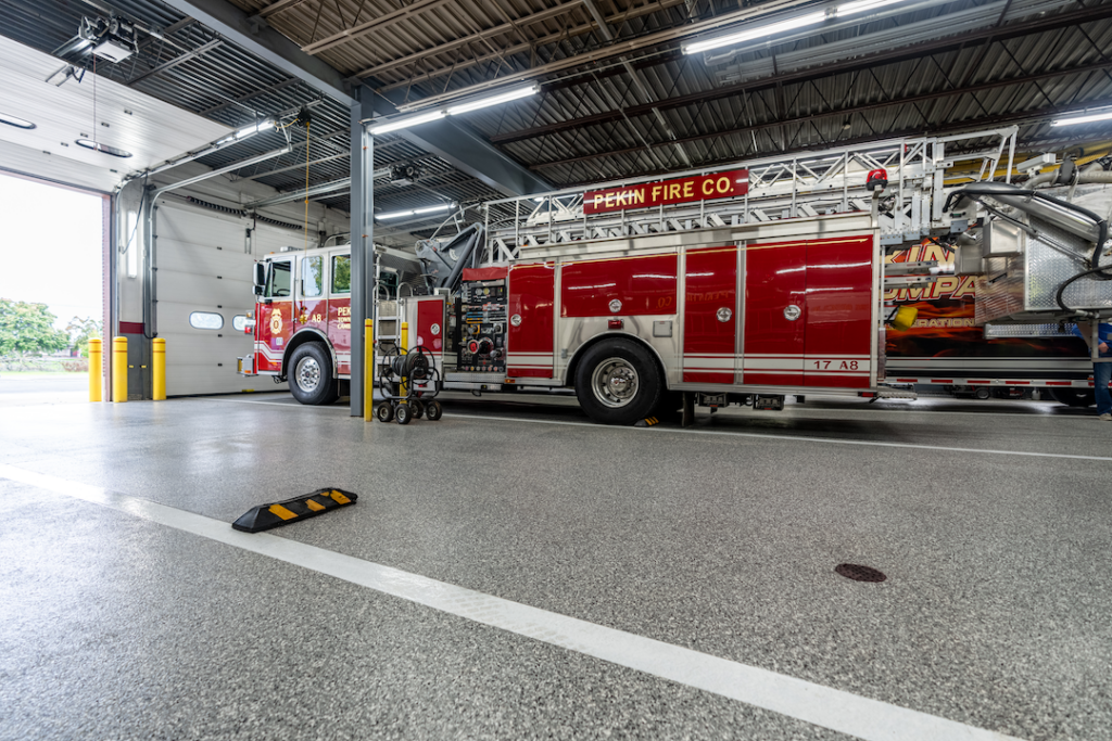 industrial polyurea coated concrete floors in firehouse with a firetruck