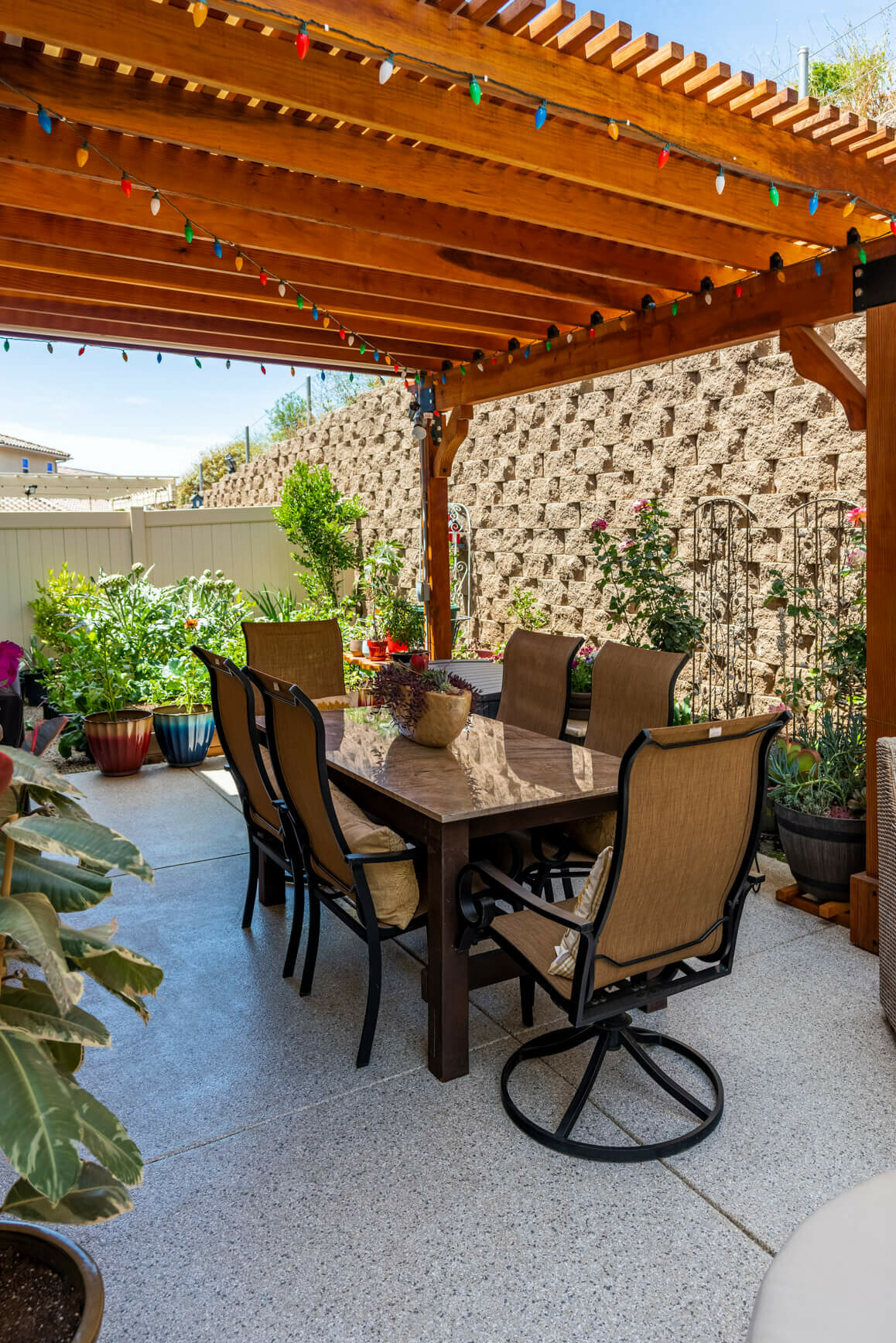 penntek patio fully furnished with plants and table and chairs