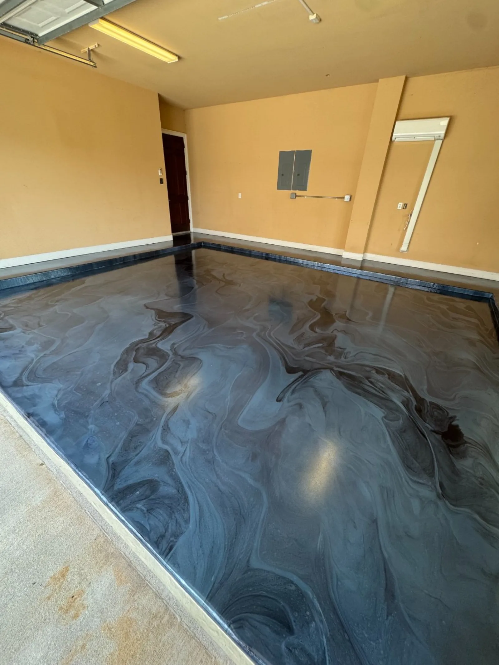 Finished residential garage floor by Elite Coatings on the Gulf Coast