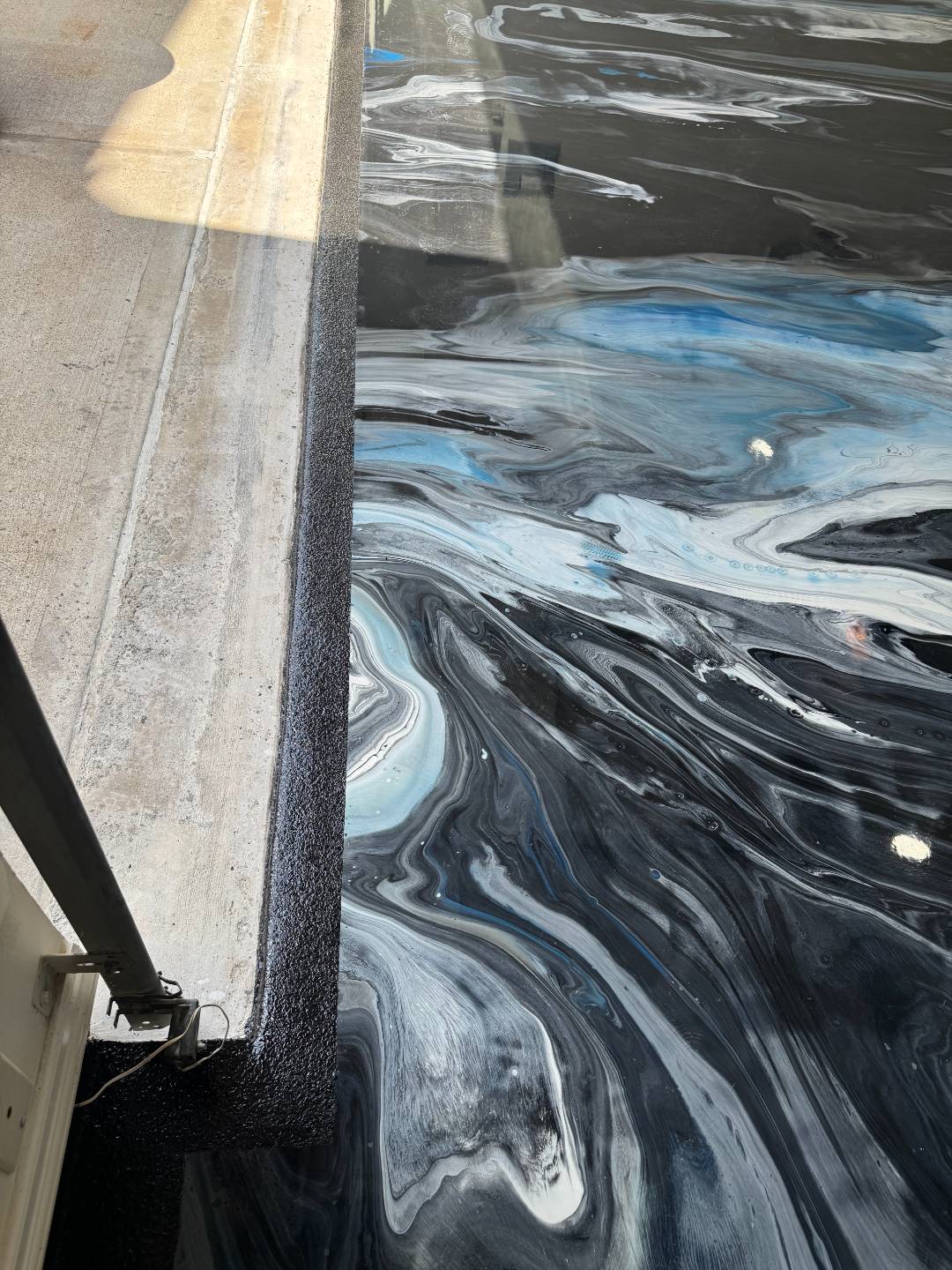 After-photo of a completed flake epoxy floor by Elite Coatings