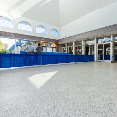 An event center with a sleek, durable Penntek-coated floor, showcasing its polished finish and robust surface, ideal for high-traffic areas and large gatherings. Elite Coatings offers fast-installation of polyurea concrete coatings for Houston home and businesses.